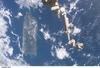 The Space Station Remote Manipulator System (SSRMS) or Canadarm2 appears against the Caribbean Sea in this view taken from the International Space Station. Puerto Rico is the large island on the left side of the frame. Image courtesy of NASA.