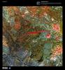 The prominent crimson streak in the center of this false-color satellite image represents the remains of a 50 km (31 mi) lahar (volcanic mudflow) that cut a strip of barren rock through rich vegetation surrounding the Anyuyskiy Volcano. The currently dormant volcano is the orange circular shape at the right end of the streak. Remote and largely inaccessible, the Kamchatka Peninsula is a rugged collection of towering volcanic peaks, steep valleys, active geysers, and wild, snow-fed rivers and streams.  This volcano is part of the UNESCO World Heritage Site "Volcanoes of Kamchatka." For other active volcanoes in Russia, see the Natural hazards-volcanism subfield in the Geography section. Image courtesy of USGS.