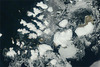 Russia’s northernmost territory, Franz Josef Land, is an archipelago of 191 islands in the northeastern Barents Sea. On 17 August 2011, clear skies allowed NASA’s Terra satellite this unobstructed view. Clouds fringe this natural-color scene, like curtains held back from a window. Around the islands, sea ice forms serpentine shapes of light gray and dull white. The glaciers that cap many of the islands are bright white. In ice-free areas, land cover is pale brown, typical of tundra.
Situated about 1,000 km (625 mi) from the North Pole, Franz Josef Land has a punishing climate. The average summertime temperature is just 2 degrees Celsius (35 degrees Fahrenheit), and the average wintertime temperature is -22 degrees Celsius (-8 degrees Fahrenheit). Vegetation includes lichens, mosses, and Arctic flowering plants. Image courtesy of NASA/Jeff Schmaltz.
