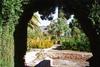 Alhambra garden viewed through an archway, Granada.