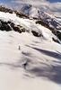 Snow, rocks, shadows, and peaks merge upward into the clouds. 