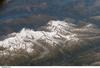 Three of the higher peaks of the Bernese Alps are visible -Jungfrau (4,158 m), Moench (4,089 m), and Eiger (3,970 m). To the east and south of the Jungfrau is the Aletsch Glacier, clearly marked by dark medial moraines extending along the glacier's length parallel to the valley axis. Moraines are formed from rock and soil debris scoured along the sides of mountain glaciers that gradually accumulate in the middle of the glacier and are carried along the flow direction. Lake Brienz to the northwest is glacially carved. Image courtesy of NASA.