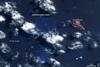 In mid-March 2009, a plume of ash and gas burst out of the ocean as an undersea volcano began to erupt in the South Pacific nation of Tonga. Small sections of the rim of the large volcano had been above water, forming the islands of Hunga Tonga and Hunga Ha'apai (center). The eruption occurred at two vents, one submerged and the other on Hunga Ha'apai. The eruption pumped out enough rock and ash that by 25 March, when NASA's Terra satellite captured this image, the submerged vent was surrounded by new land.

The new land is the dark mass south of Hunga Ha'apai. It was not present in an earlier image taken on 14 November 2006 (next photo). In this image, clouds cover the space between the new land and Hunga Ha'apai, but the new land connects Hunga Ha'apai with the underwater vent, essentially enlarging the small island. The vent itself is the nearly perfectly circular hole near the southern edge of the new land.

Also revealed are some of the other impacts of the eruption. The ocean around the erupting volcano is bright blue, likely colored with ash, rock, and other volcanic debris. The eruption killed or damaged plants on Hunga Ha'apai. In this false-color image, plant cover is red. In 2006, Hunga Ha'apai had supported vegetation, but after the eruption, the island was black. Either the plants were buried in ash or dead in the wake of the eruption. Photo courtesy of NASA.

