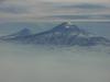 A view of Mount Ararat in eastern Turkey through the fog. The highest of its two peaks, Greater Ararat, is the tallest mountain in Turkey at 5,166 m (16,949 ft). Although located some 32 km (20 mi) from the Armenian border, the dormant volcano dominates the skyline of Yerevan, Armenia's capital. This photo was snapped after take off from the Yerevan airport.