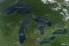 This image is a rare satellite view of a cloudless summer day over the entire Great Lakes region. The Great Lakes comprise the largest collective body of fresh water on the planet, containing roughly 18 percent of Earth's supply. Only the polar ice caps contain more fresh water. The region around the Great Lakes basin is home to more than 10 percent of the population of the United States and 25 percent of the population of Canada.
Open water appears blue or nearly black. The pale blue and green swirls near the coasts are likely caused by algae or phytoplankton blooms, or by calcium carbonate (chalk) from the lake floor. Photo courtesy of NASA.