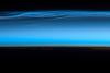 Polar mesospheric clouds - also known as noctilucent or "night shining" clouds - form between 76 to 85 km (47 to 53 mi) above the Earth's surface, near the boundary of the mesosphere and thermosphere, a region known as the mesopause. At these altitudes, water vapor can freeze into clouds of ice crystals. When the sun is below the horizon and the ground is in darkness, these high clouds may still be illuminated, lending them their ethereal, "night shining" qualities.

Polar mesospheric clouds have been observed from all human vantage points in both the Northern and Southern Hemispheres - from the surface, in aircraft, and from spacecraft - and tend to be most visible during the late spring and early summer. Image courtesy of NASA.