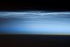 Polar mesospheric clouds - also known as noctilucent or "night shining" clouds - form between 76 to 85 km (47 to 53 mi) above the Earth's surface, near the boundary of the mesosphere and thermosphere, a region known as the mesopause. At these altitudes, water vapor can freeze into clouds of ice crystals. When the sun is below the horizon and the ground is in darkness, these high clouds may still be illuminated, lending them their ethereal, "night shining" qualities.

Polar mesospheric clouds have been observed from all human vantage points in both the Northern and Southern Hemispheres - from the surface, in aircraft, and from spacecraft - and tend to be most visible during the late spring and early summer. Image courtesy of NASA.