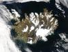 Summer temperatures melt snow and ice on much of Iceland's surface, as shown on this satellite image. The lack of uniform snow cover allows permanent (though shrinking) icefields to show through (particularly Vatnajokull in the southeast), and highlights the island's rugged coastline. Scores of fjords edge the island, resembling feathers waving out into the waters of the northern Atlantic Ocean (bottom) and Greenland Sea (upper left). Photo courtesy of NASA.
